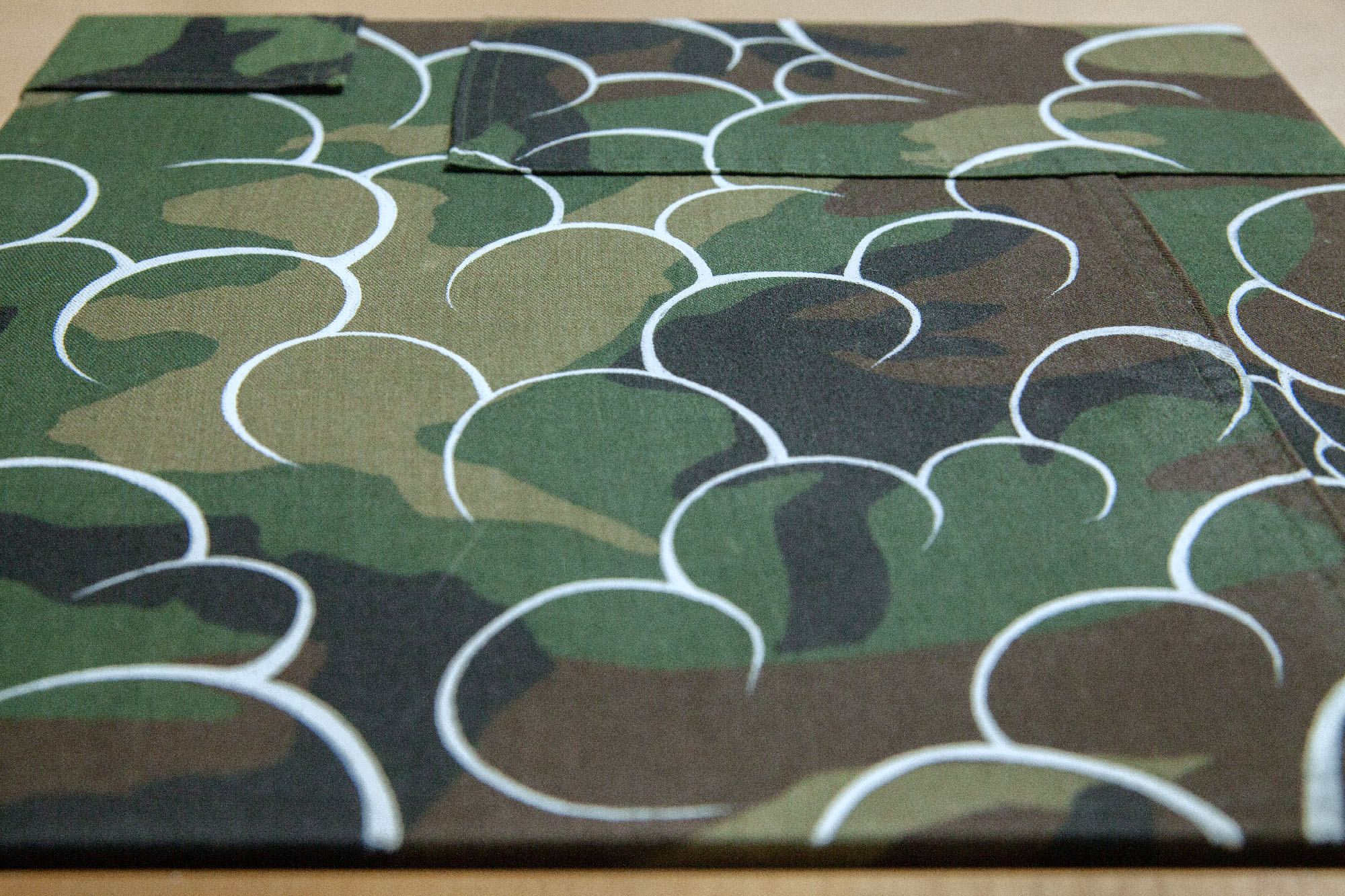 White outlined clouds filled over woodland camouflage pattern